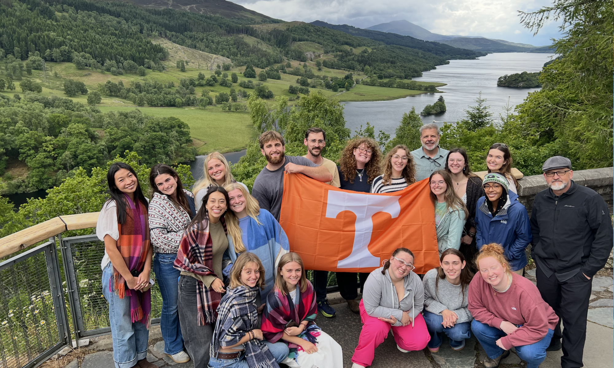 Students smiling with Tennessee flag